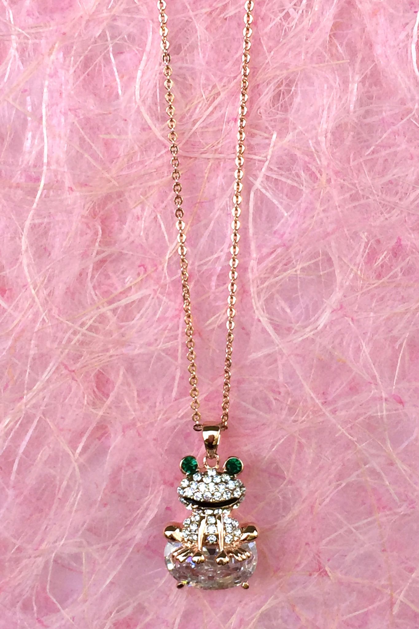 A beautiful butterfly pendant made of mother of pearl and emblazoned with small glittering crystals on a gold metal base. J020010